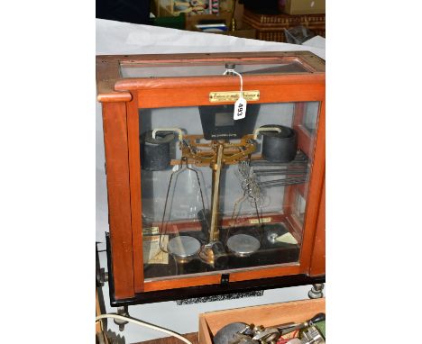 A SET OF RELEASE-O-MATIC BALANCE SCALES, made by L Oertling Ltd, Model 128, serial number 41955, in a wooden framed glass cas