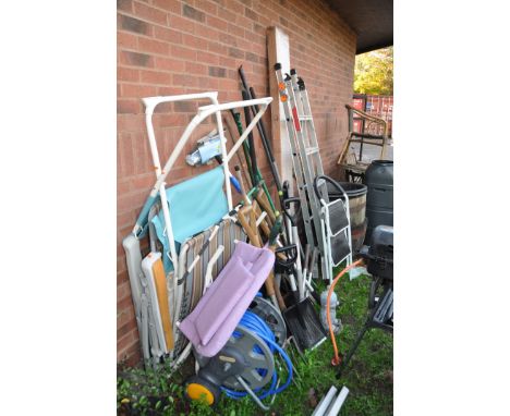 A LARGE QUANTITY OF GARDEN TOOLS AND FURNITURE including a boxed and unopened barbecue shelter, step ladders folding chairs f