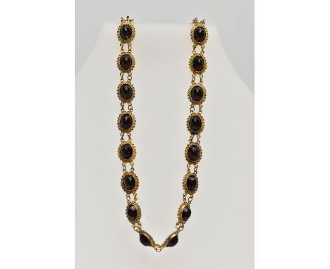 AN EARLY 20TH CENTURY RED PASTE SET CHOCKER NECKLACE, set with a series of oval cut red pastes, each collet set within a cann