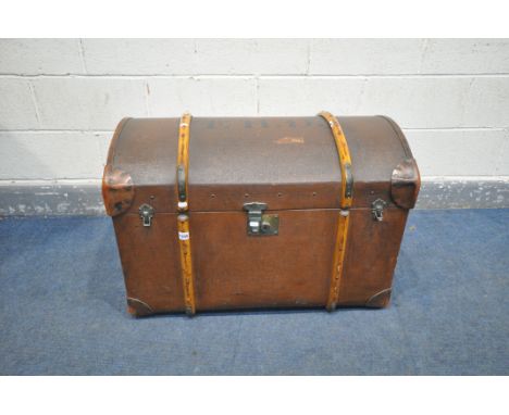 A VINTAGE CANVAS DOMED TRAVELING TRUNK, wooden banded, and leather corner patches, F.H.D. stamped to top, length 85cm (good c