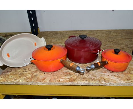 FOUR PIECES OF LE CREUSET CAST IRON ENAMELLED COOK WARES, comprising a dark red casserole dish, diameter 25cm excluding handl