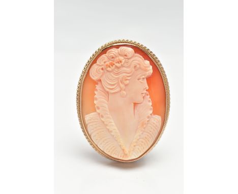 A 9CT GOLD CAMEO BROOCH, of an oval form, carved shell depicting a lady in profile, collet set to a fine rope twist surround,