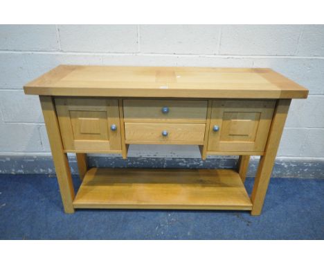 A SOLID LIGHT OAK SIDEBOARD, with two doors flanking two drawers, length 123cm x depth 44cm x height 78cm (condition - sun bl