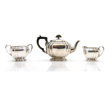 A silver three piece tea service by Cooper Brothers &amp; Sons Ltd, Sheffield 1959, comprising a teapot, twin-handled sugar b
