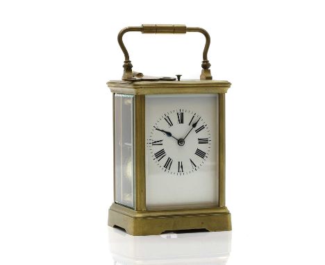 A brass carriage clock early 20th century, the white enamel dial with Roman numerals, to a bevelled glass case, with a repeat