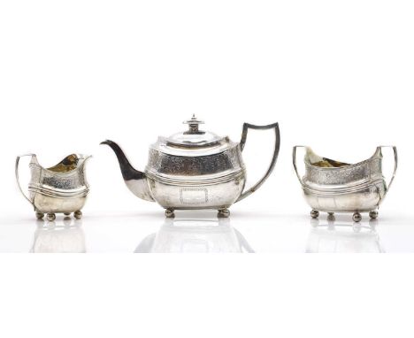 A George III silver tea service London 1809 and 1810, comprising a teapot, 29cm wide, a twin-handled sugar bowl, 19cm wide, a