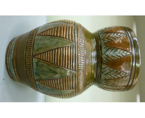 A Linthorpe pottery vase, designed by Christopher Dresser of bulbous form, having a waisted, wide rim, decorated in tones of 