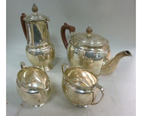 A four piece silver tea set of bulbous form  comprising a teapot, having a swept spout, an insulated handle and knop to the o