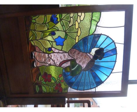A 1930s oak framed firescreen  comprising a coloured bead glazed panel (25'' x 21'') featuring a Japanese woman with a paraso