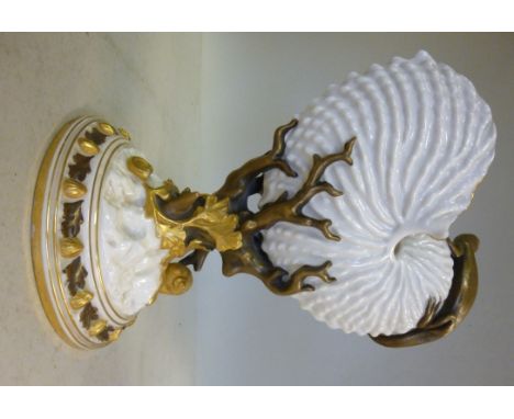 A late 19thC Royal Worcester ivory glazed and gilded nautilus shell vase with a lizard, on a moulded coral, seaweed and shell