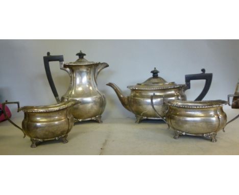 A four piece silver tea set of oval, ogee, panelled form with shell and gadrooned borders, on cast paw feet, the teapot havin