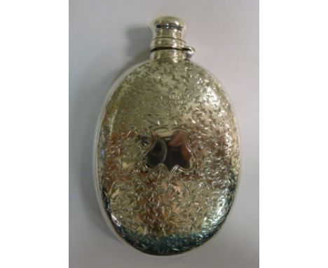 A mid Victorian silver hip flask of oval, curved, cushion form, having an outset, hinged, rotating, mushroom shaped cap, in a