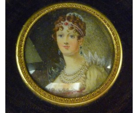 A 20thC head and shoulders portrait miniature, a young woman bedecked in jewels, in a glazed, turned mahogany frame  3.5''dia