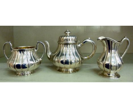 An early Victorian three piece silver tea set of bulbous, segmented design  comprising a teapot with a swept spout and an ins