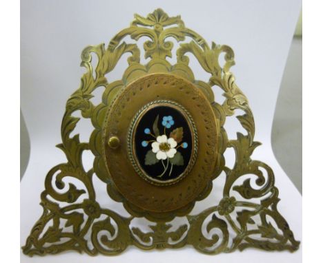 An early 20thC oval brass framed portrait miniature, enclosed by a hinged cover, featuring a floral, pietra dura tablet, set 