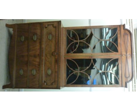 A George III mahogany cabinet bookcase, the upper part having a raised cornice, over a pair of satinwood string inlaid, glaze