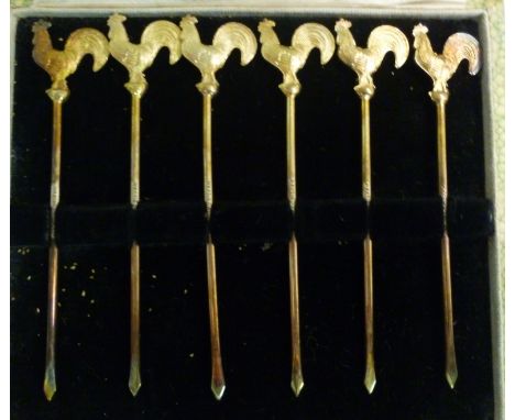 A set of six silver coloured metal cocktail sticks, each finial fashioned as a cockerel  stamped Sterling  cased