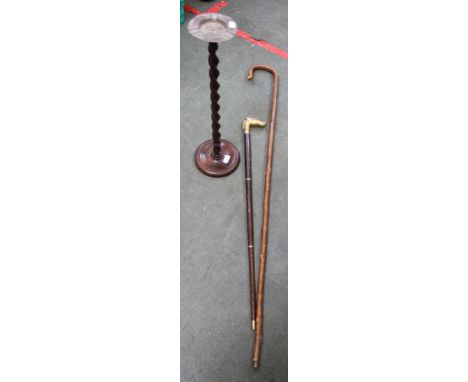 A walking staff, a horse head walking stick and a barley twist ash tray