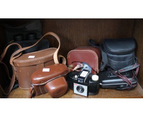 A shelf containing a good selection of cameras and binoculars (7)