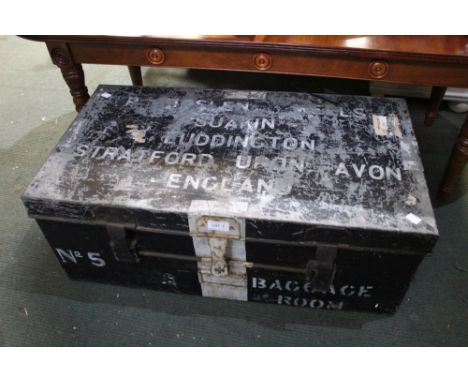 A vintage metal travel trunk with original stickers in situ