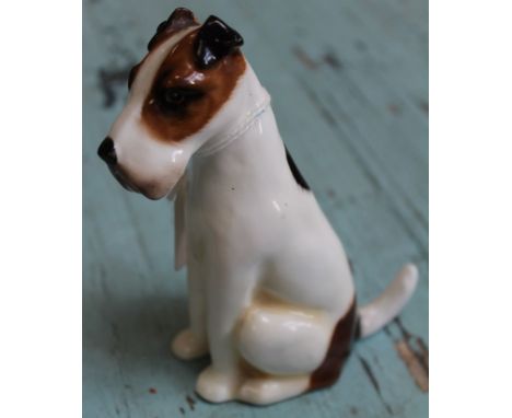 A Royal Doulton ceramic seated Fox Terrier, HN910, impressed date 3-3-29, 13.5cm high