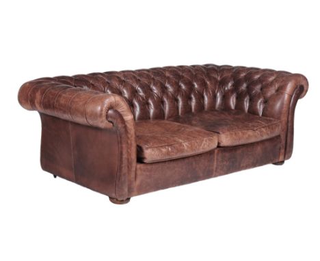  A buttoned leather upholstered sofa in Victorian style,   retailed by Conran, of recent manufacture,  the rectangular back a