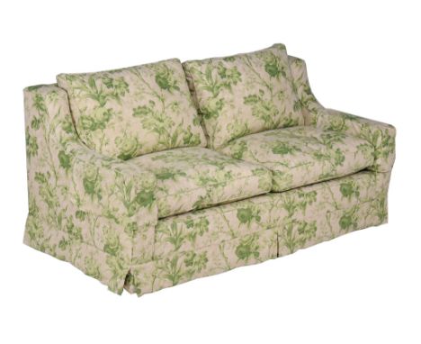  An ochre and green upholstered sofa  , of recent manufacture, probably Colefax and Fowler, covered in fabric with an overall