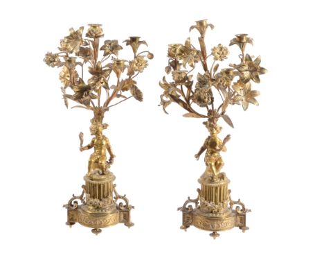  A pair of French gilt metal five light candelabra in Louis XV taste,   late 19th century, the sockets rising on stems amongs
