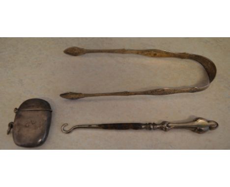 Silver sugar tongs, silver vesta case and a silver handled button hook, total weight 2.1oz