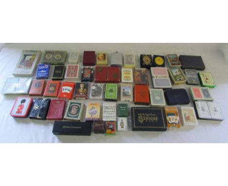 Collection of various playing cards and a set of dominoes