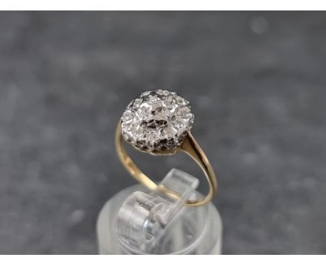 A 9ct gold diamond cluster ring, London 1985, size K 1/2, gross weight 2.1g. 