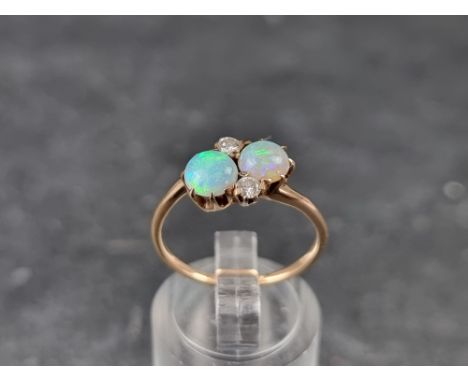 A 9ct gold diamond and opal crossover ring, size N 1/2, gross weight 2.2g. 
