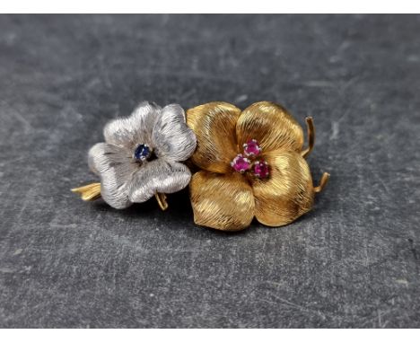 A Garrard &amp; Co 18ct yellow and white gold floral brooch, set three rubies and one sapphire, 50mm, gross weight 18.2g, in 