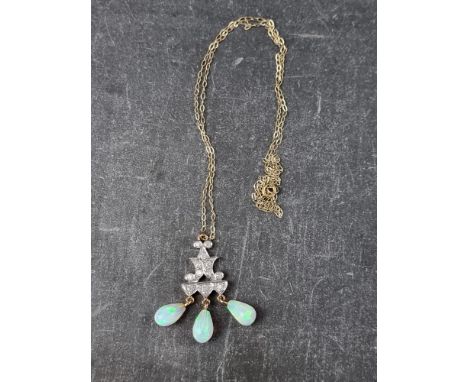 A yellow metal diamond and opal pendant, set twelve diamonds with three opal drops, 28mm high, on fine yellow metal chain, cl