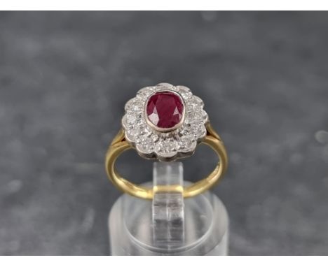 An 18ct gold ruby and diamond cluster ring, by V &amp; Co, London 1997, size M 1/2, gross weight 5.4g. 