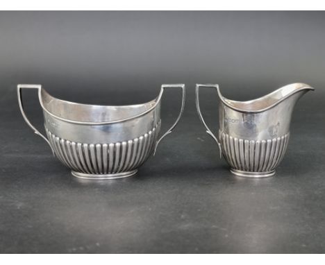 A silver cream jug and matching sugar bowl, by&nbsp;William Hutton &amp; Sons Ltd, London 1904, height to handles on each 9cm