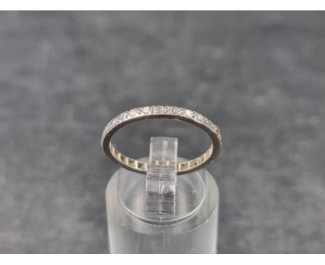 A white metal and diamond eternity ring,&nbsp;size K. 