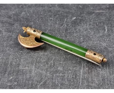 A yellow metal mounted jade novelty 'axe' brooch, 61mm high, with base metal pin. 