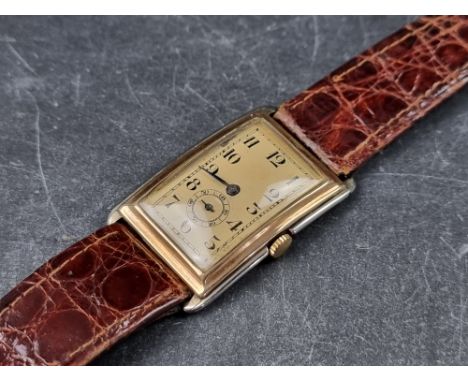 A Swiss Art Deco two tone 9ct gold manual wind wristwatch, 24 X 31mm, the movement stamped 63, on replacement leather strap. 