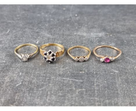 A yellow metal ruby and diamond three stone ring, size P; together with two 18ct gold and platinum diamond rings; and an 18ct