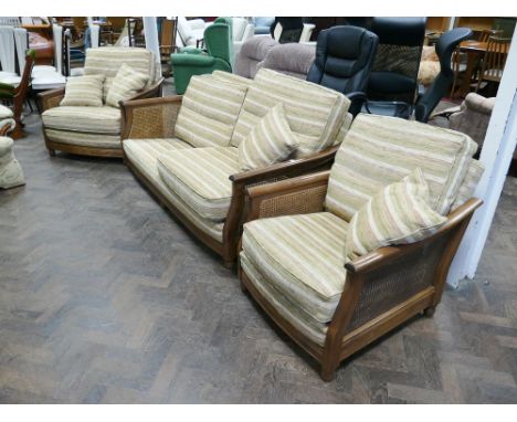 An Ercol oak framed Bergere style 3 piece lounge suite with gold and cream striped cushions, 1 cushion from settee missing un