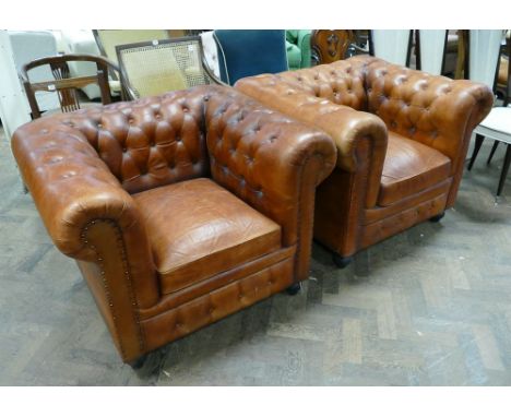A pair of brown button leather upholstered Chesterfield style easy chairs 