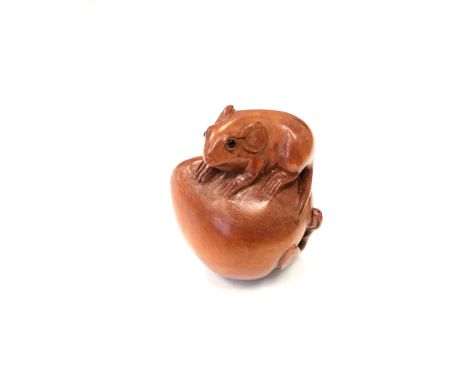 A Japanese carved fruitwood netsuke - Rat on a pumpkin. 