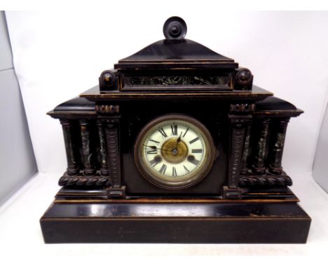 A 19th century ebonised wooden mantel clock with brass and enamel dial  