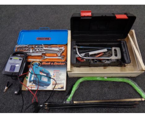 A box containing plastic toolbox containing hand tools, hand saws, battery charger,  socket set etc  