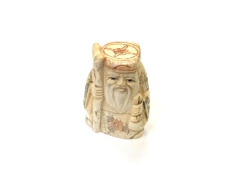 A Japanese carved bone netsuke - Village elder holding  a staff. 