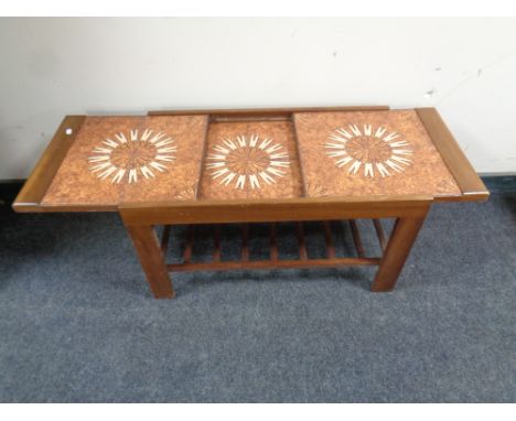 A mid 20th century teak extending tile topped coffee table 