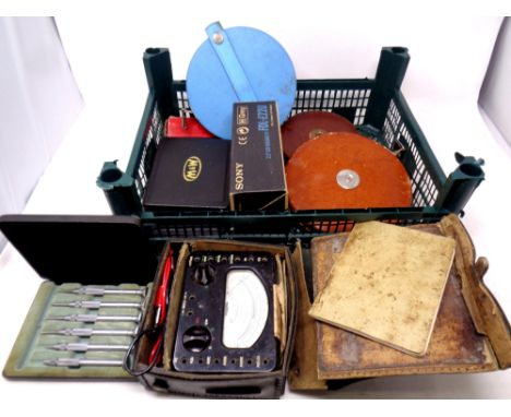 A crate containing vintage tape measures, precision tools, Sony watchman pocket TV (cased), multi range meter 