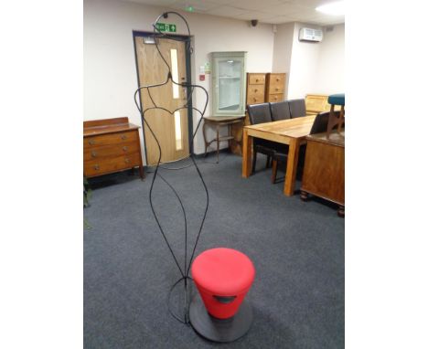 A contemporary revolving plastic and fabric upholstered stool together with a contemporary table lamp and a black wire metal 