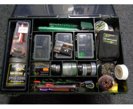 A plastic fishing box containing assorted fishing equipment to include tools, bate drills, carp care kits, PVA tape etc  